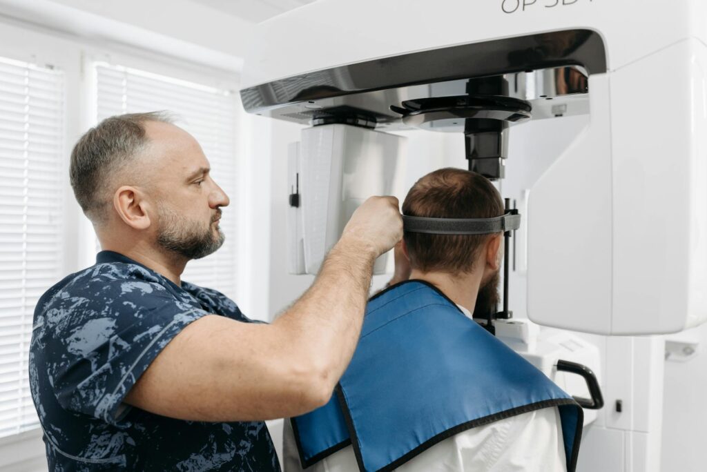 man preparing his patient for a dental x ray